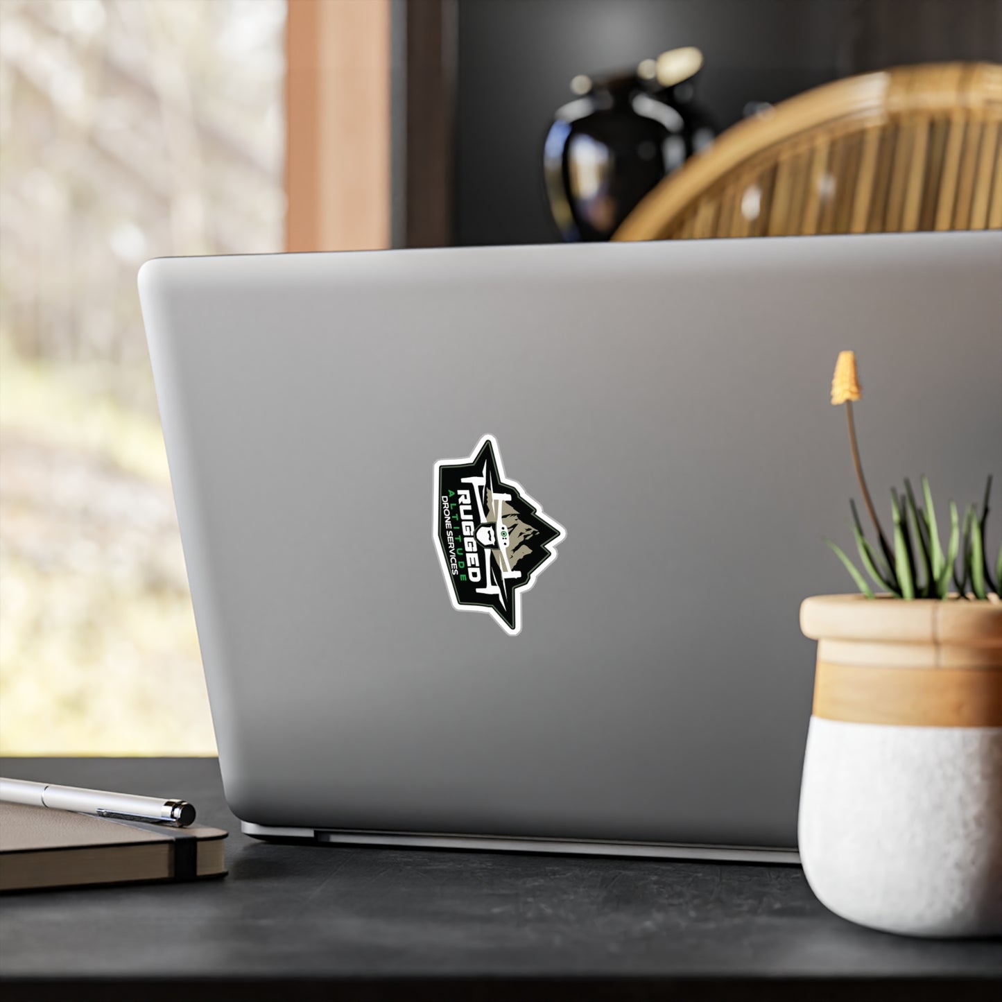 Printify drone service vinyl decals sticker on silver laptop in modern office setting